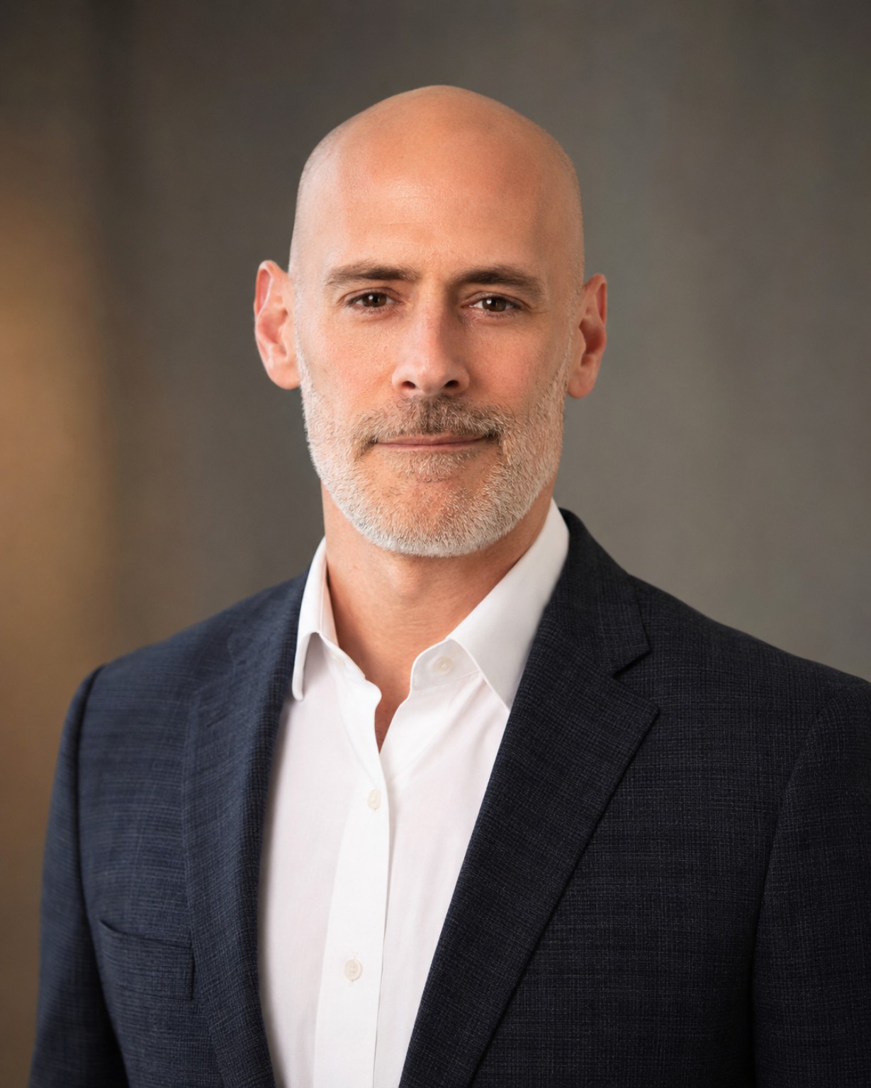 Portrait of Mark Nicolas in a dark jacket and white shirt